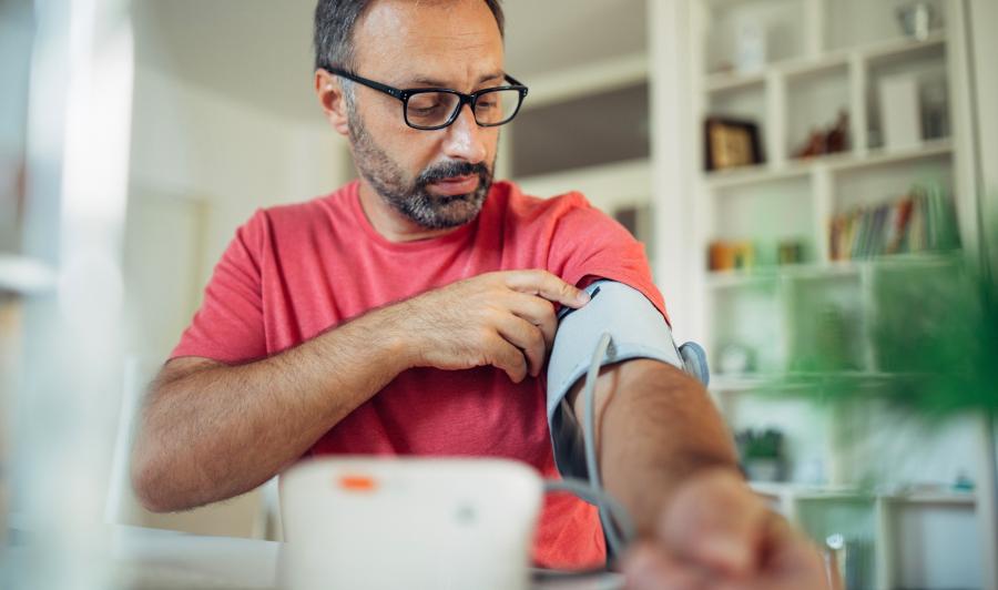 Man checking blood pressure at home