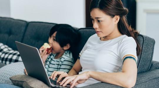 Woman using her laptop to learn more about breast cancer