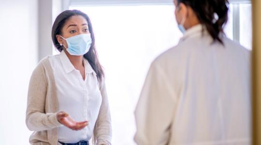 Black female patient speaking with physician